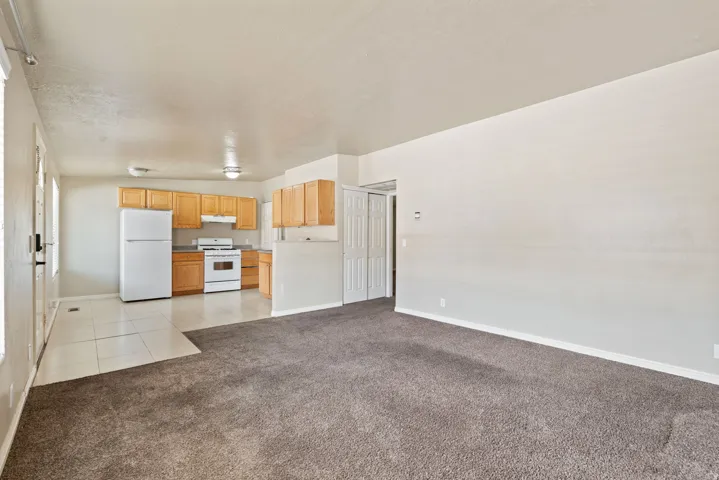 Open concept living area featuring textured carpeting