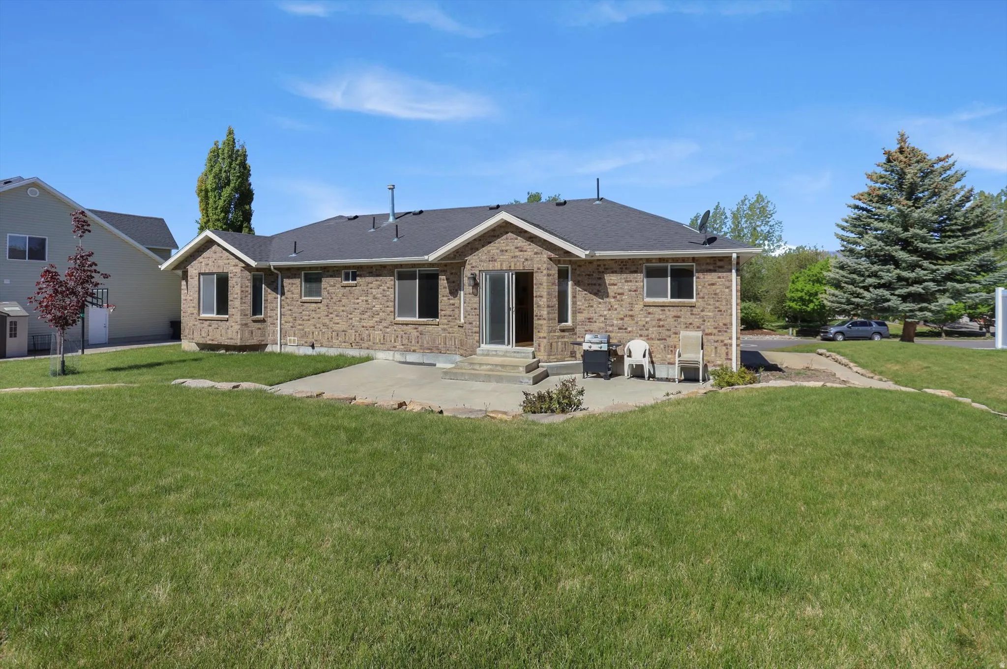 Brick exterior featuring multiple windows and a gabled roof