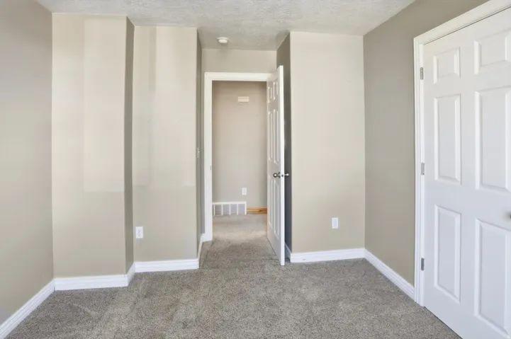 Neutral-toned walls complementing plush grey carpeting
