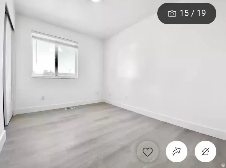 Room featuring light wood-finish flooring, white walls, and a recessed ceiling light
