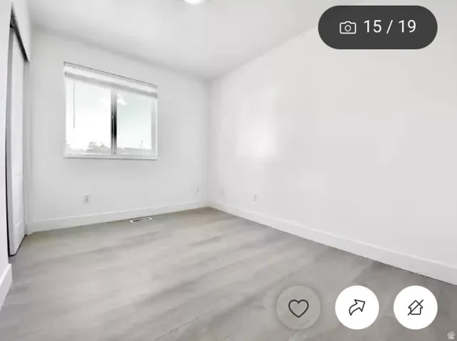 Room featuring light wood-finish flooring, white walls, and a recessed ceiling light