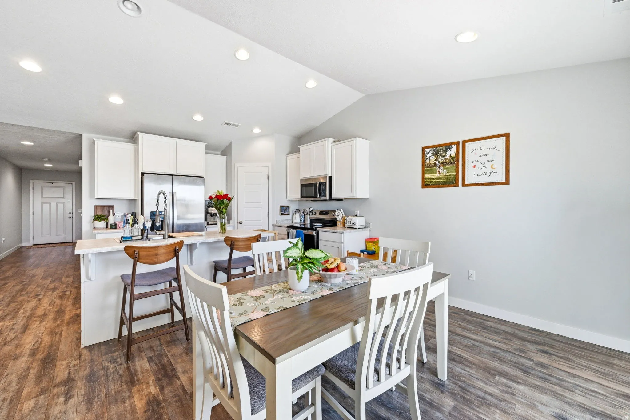 Kitchen and dining area featuring wood-finish flooring