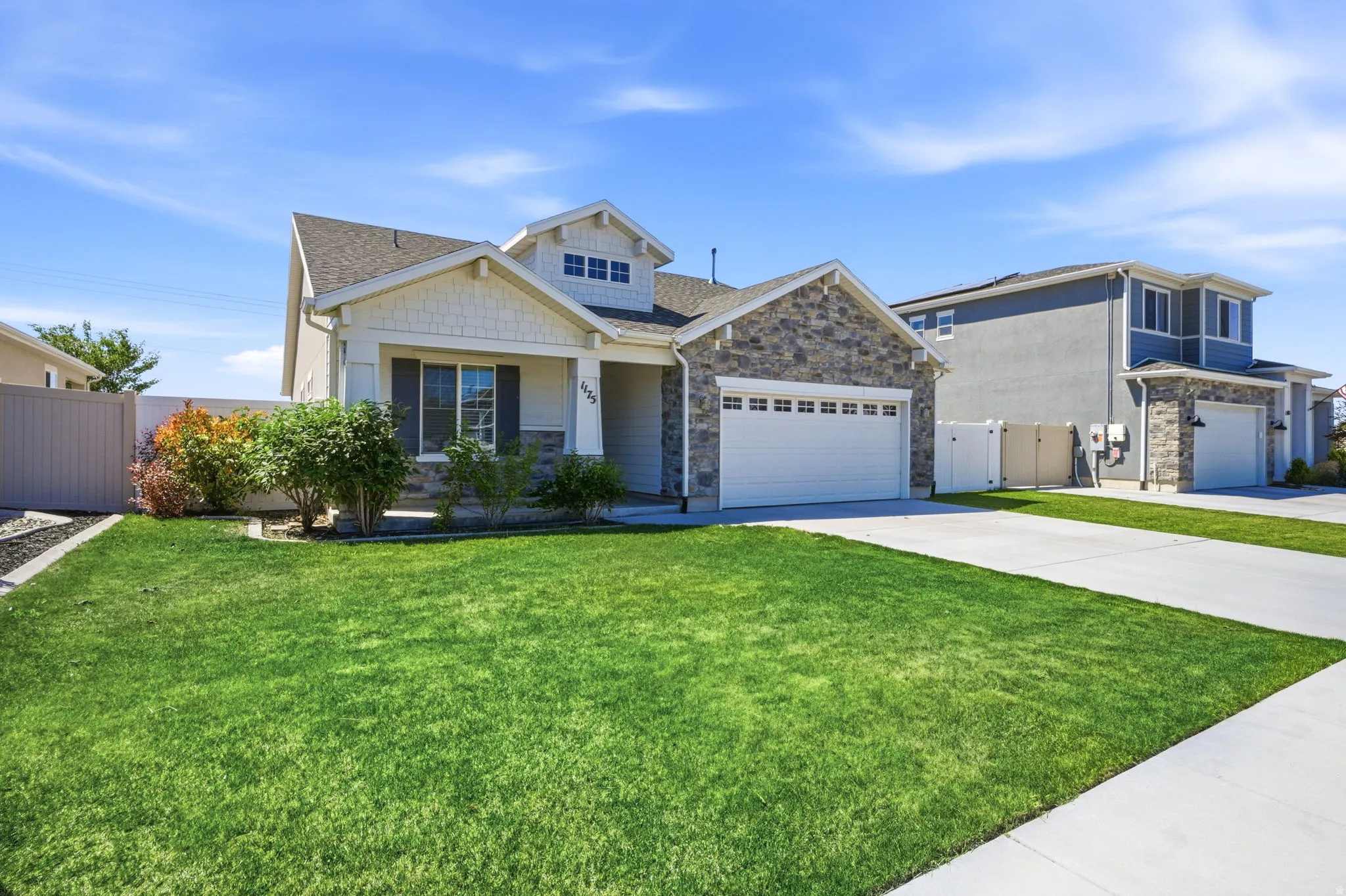Contemporary exterior featuring stone accents, horizontal siding, and gable rooflines