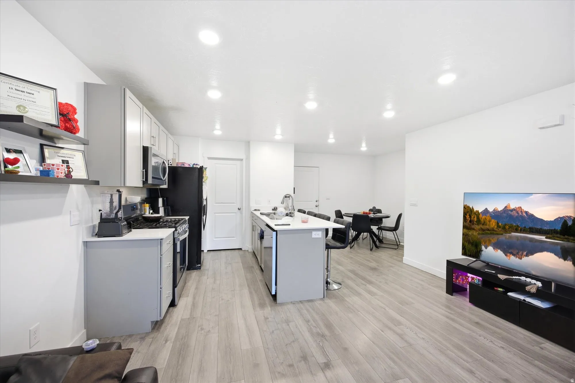 Open-concept living space featuring wood-finish flooring and recessed ceiling lighting