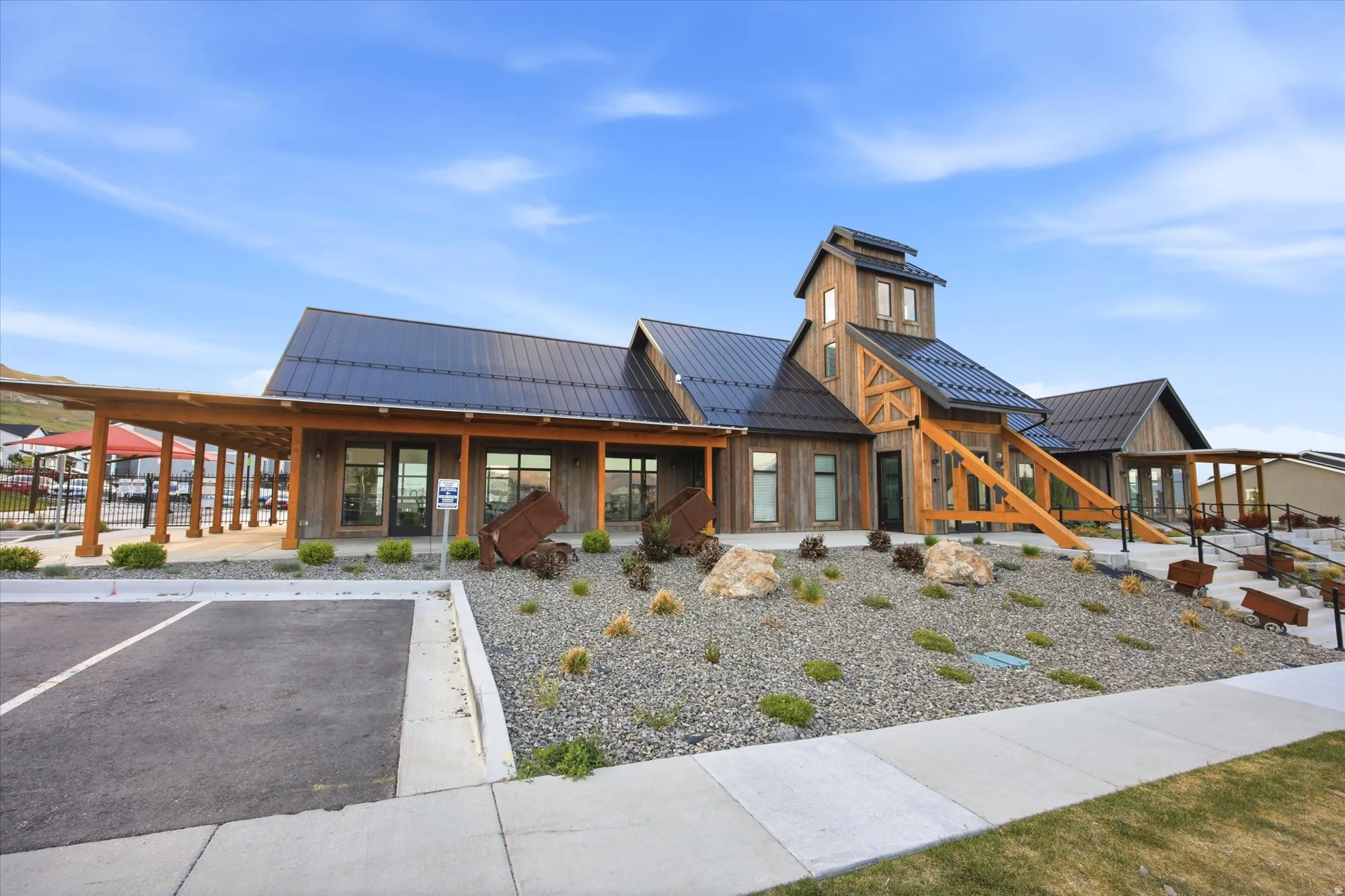 Modern rustic-style building featuring wood-finish siding and a black metal roof