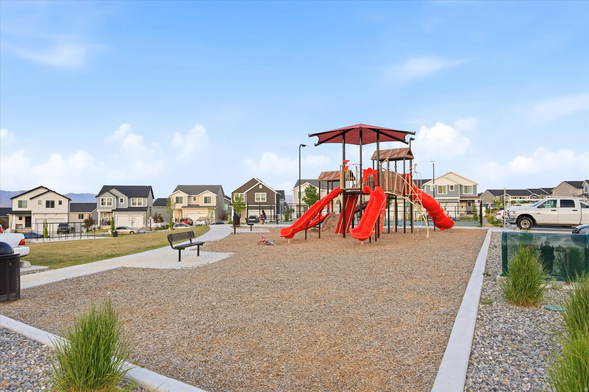 Community playground featuring a multi-level structure with slides and climbing elements