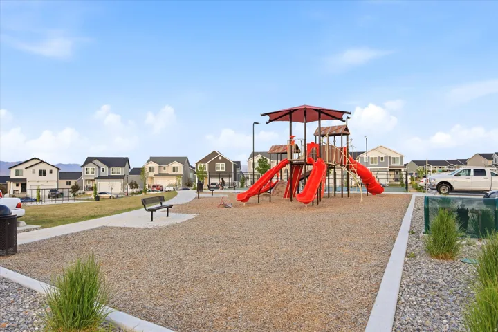 Community playground featuring a multi-level structure with slides and climbing elements