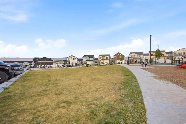 Community green space featuring a gravel path and adjacent playground area with rubberized surfacing