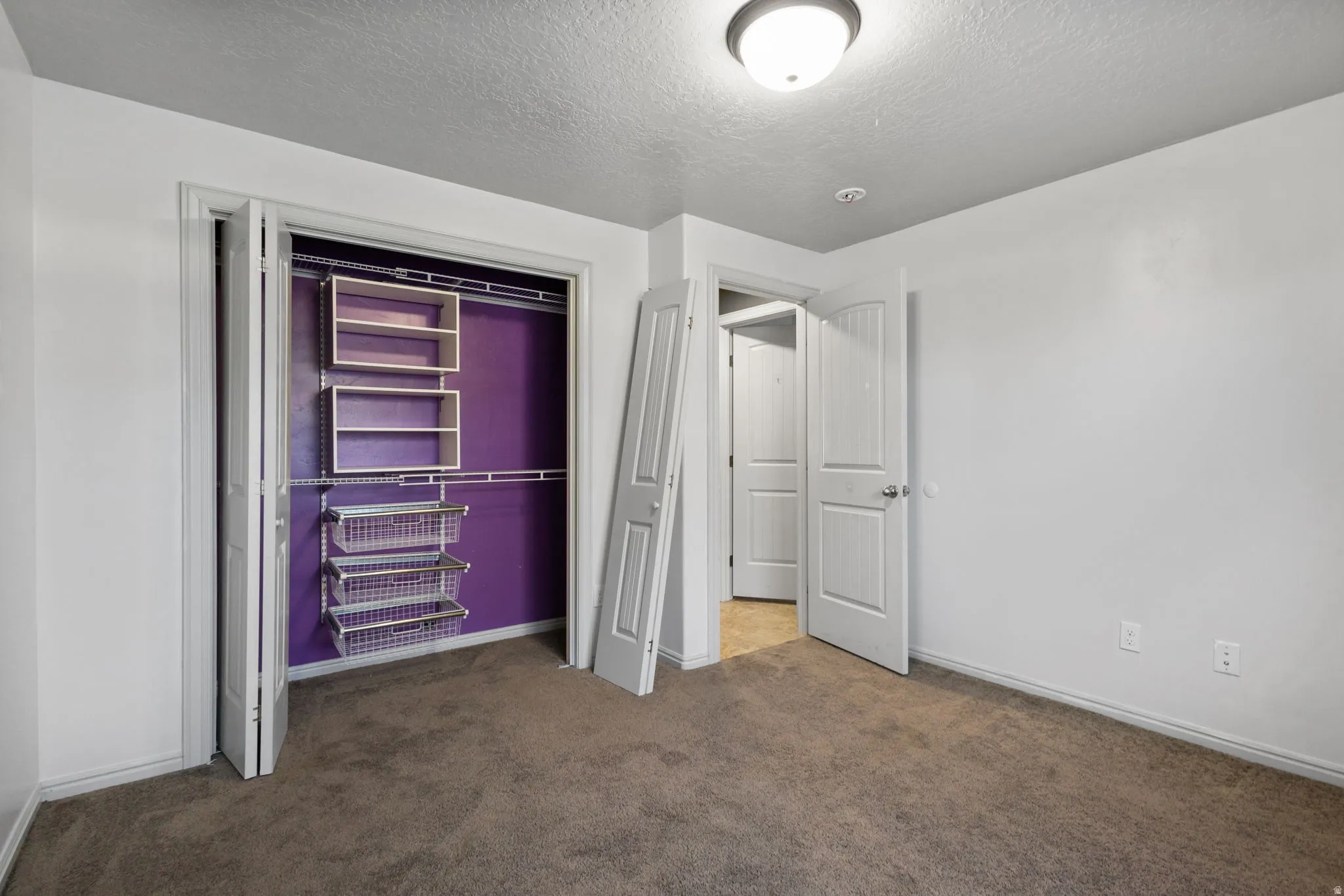 Bedroom featuring neutral-toned carpeting and white walls