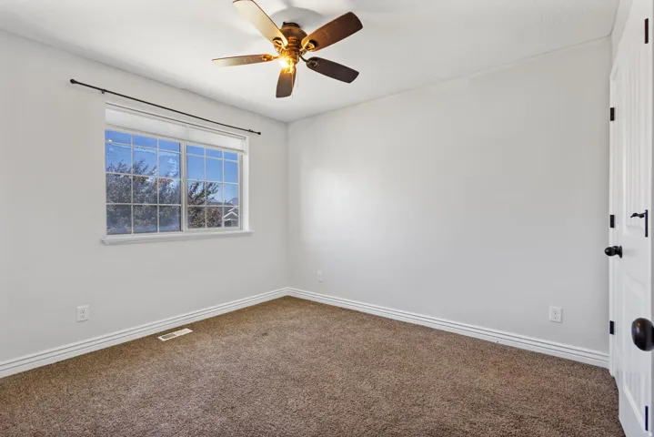 Recessed window featuring a black curtain rod, white trim, and a multi-pane design