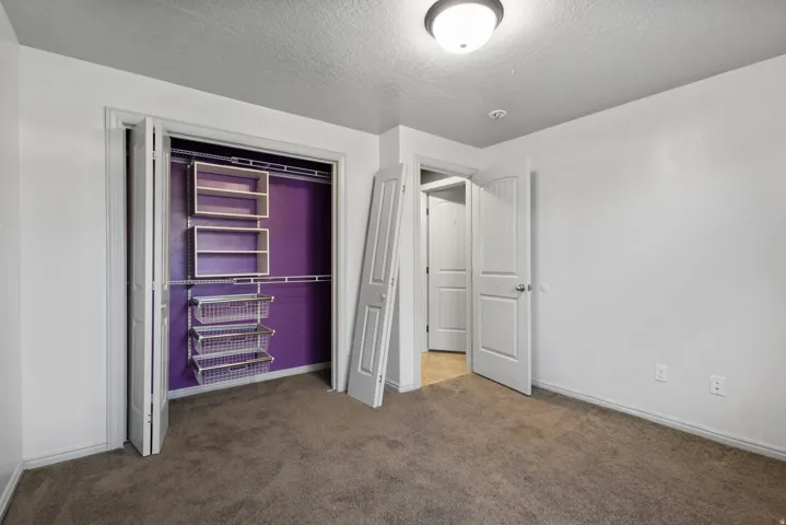 Bedroom featuring neutral-toned carpeting and white walls