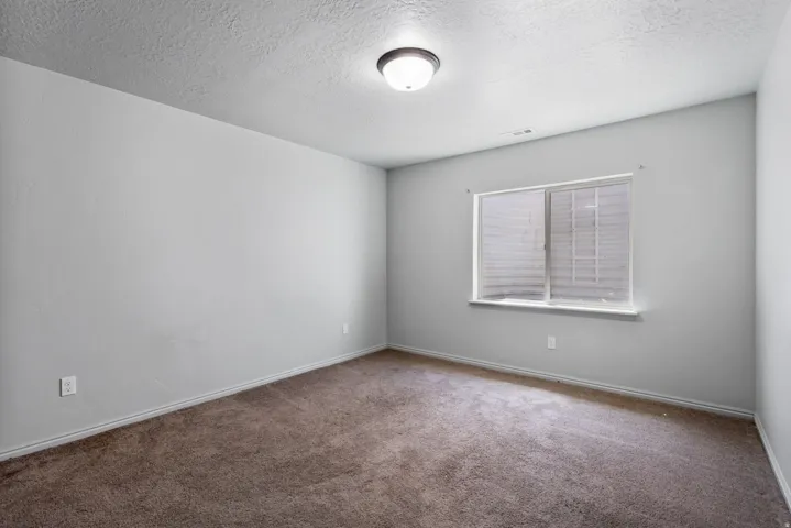Neutral wall tones complement the durable carpet flooring