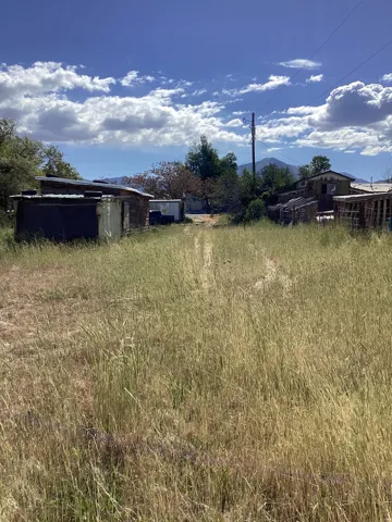 Expansive lot featuring natural, overgrown grass and a visible dirt path