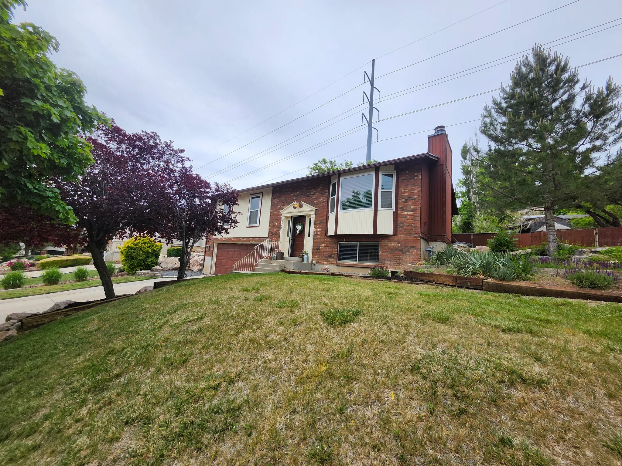 Brick and siding exterior featuring a prominent bay window