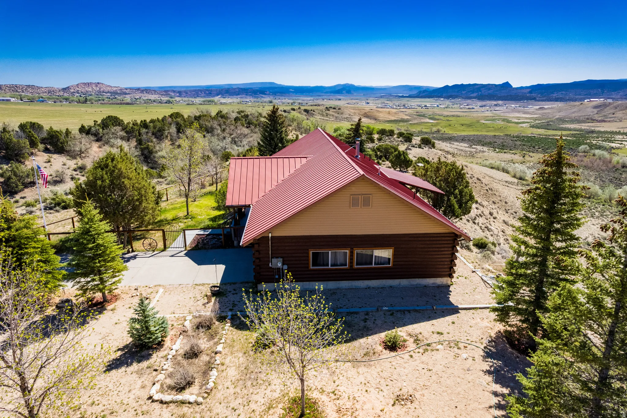 Log-style residence featuring a red metal roof and natural wood siding