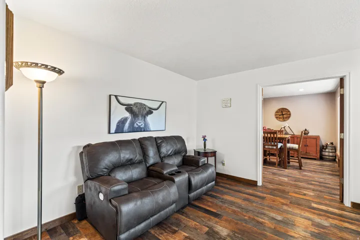 Open living space with wood-finish flooring and white walls
