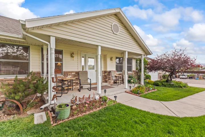 Front porch entry with vinyl siding and brick veneer detailing