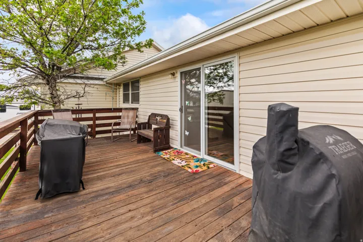 Expansive outdoor deck featuring wood flooring and a perimeter railing