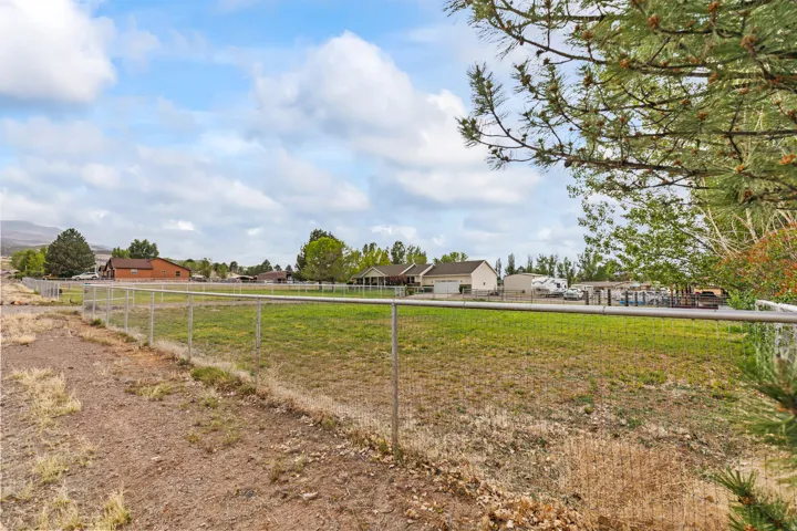 Expansive land parcel featuring a chain-link perimeter fence