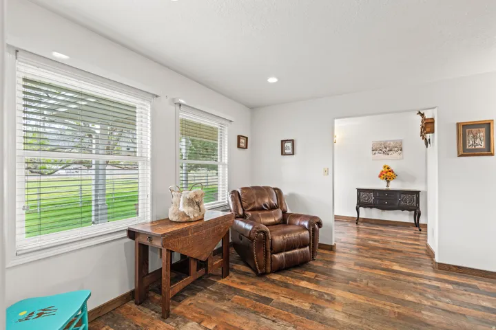 Spacious interior with wood-finish flooring, white walls, and recessed lighting