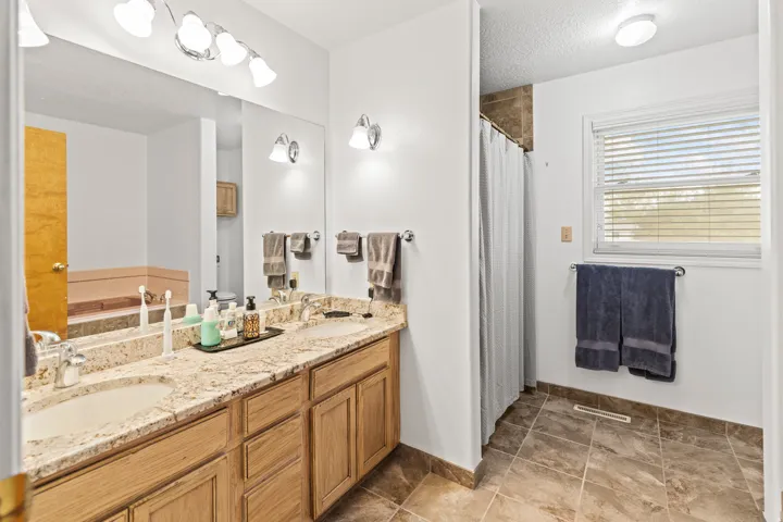 Double vanity featuring light-toned countertops and two undermount sinks
