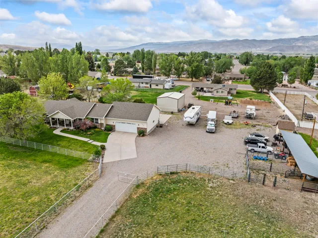 Ranch-style residence featuring a covered front porch and an attached two-car garage