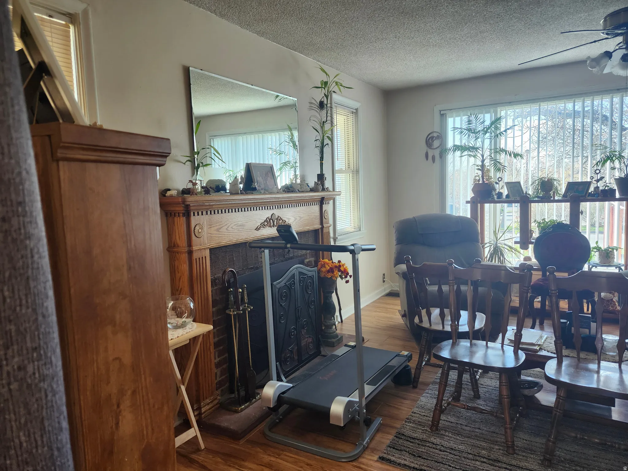 Living area featuring a prominent fireplace with an ornate wood mantel and brick surround