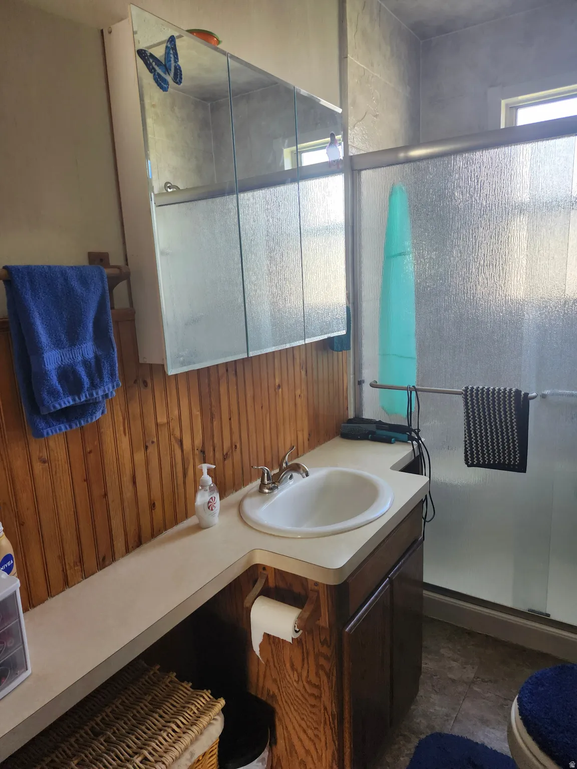 Bathroom featuring a built-in vanity with an integrated sink and a medicine cabinet with mirrored doors