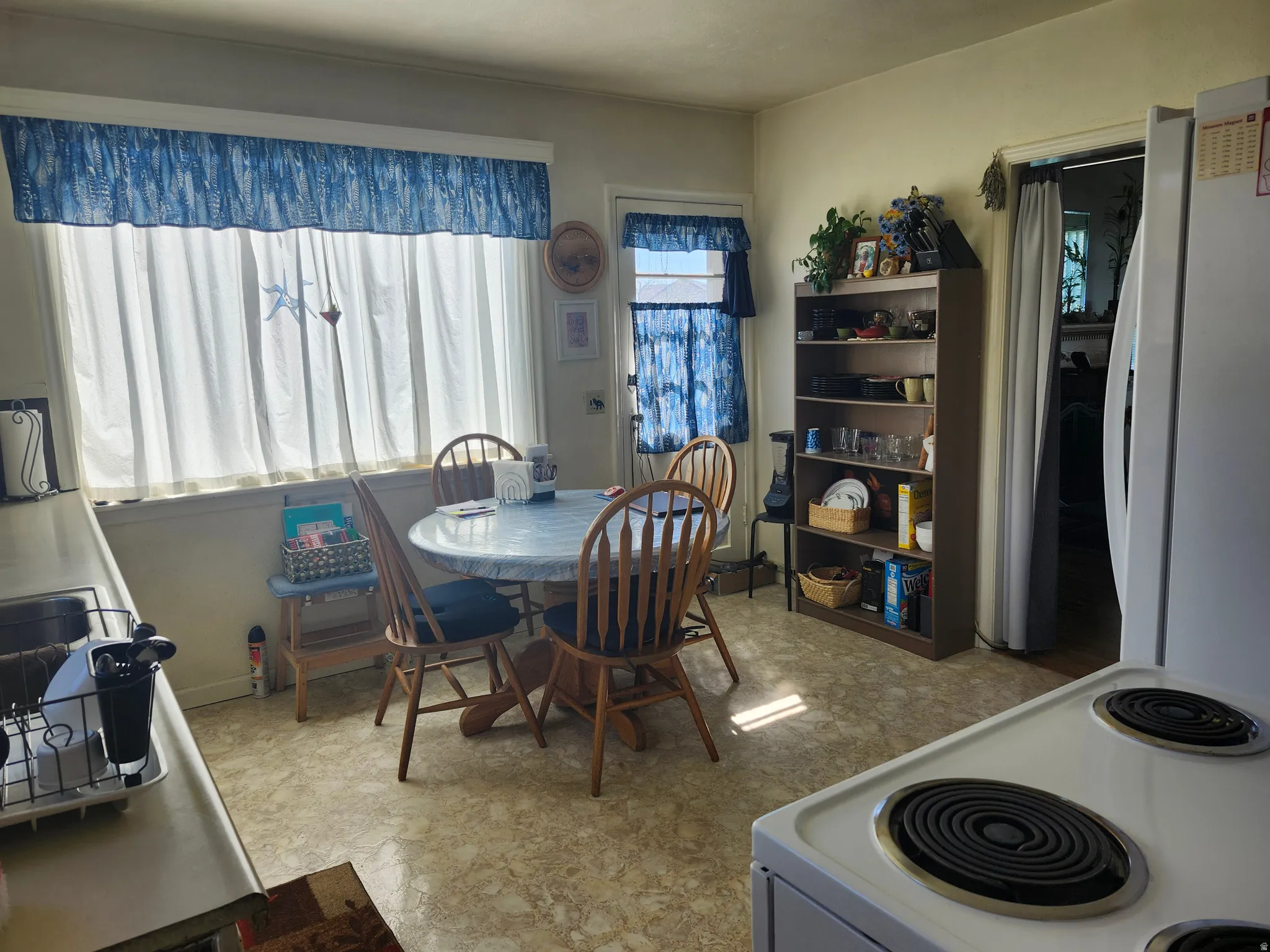 Kitchen space featuring a large window, resilient flooring, and an electric range