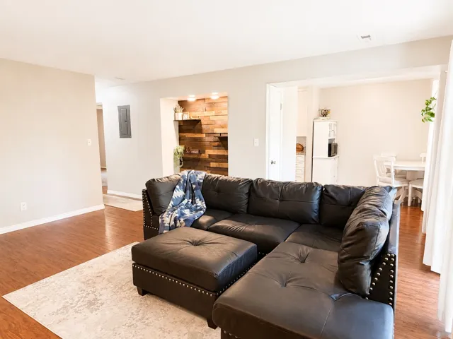 Bright and Welcoming entry Showcasing the custom wood accent wall, rich flooring and abundant natural light.