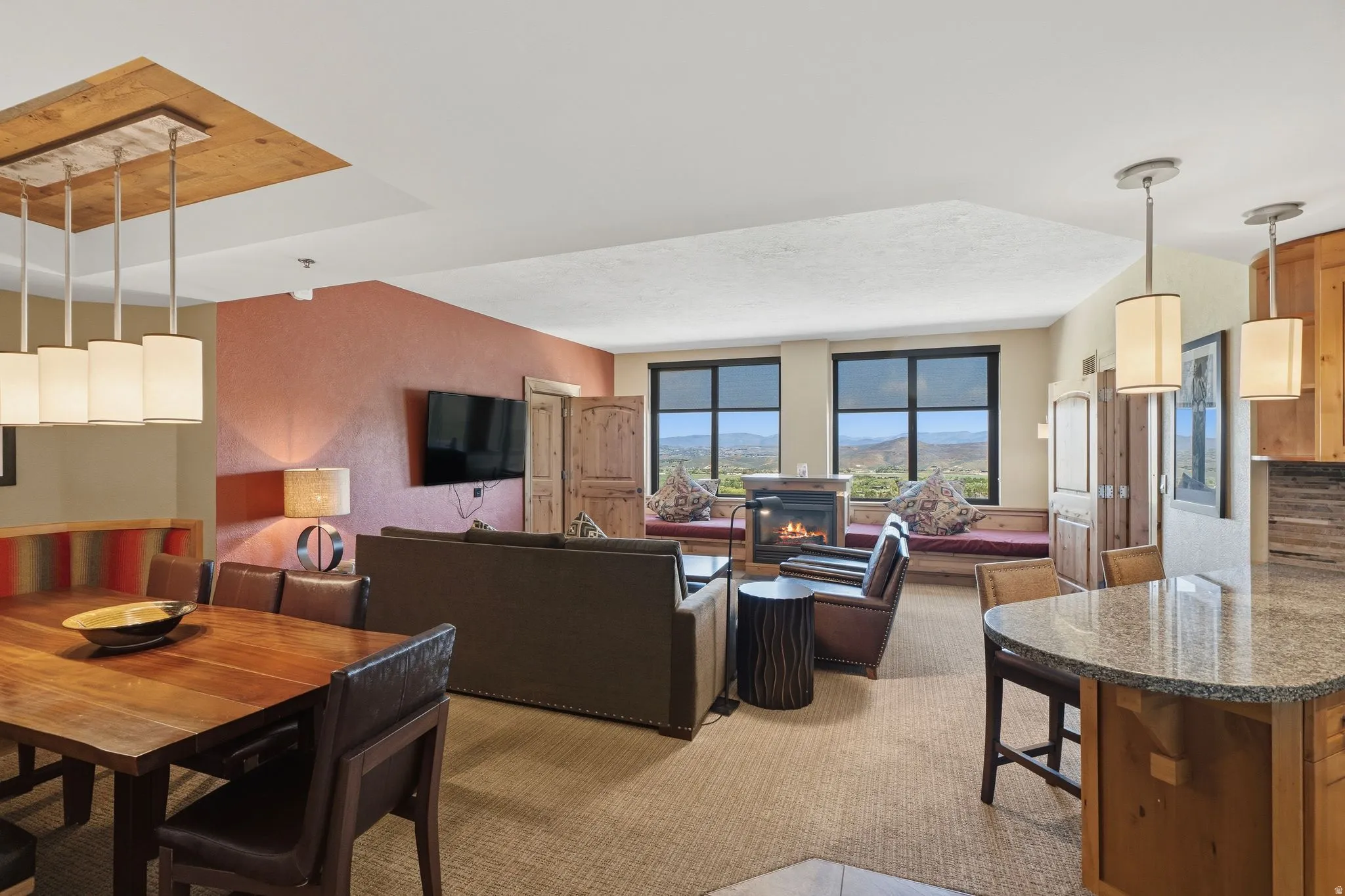 Open-concept living space featuring a living area with a fireplace, dining area, and kitchen