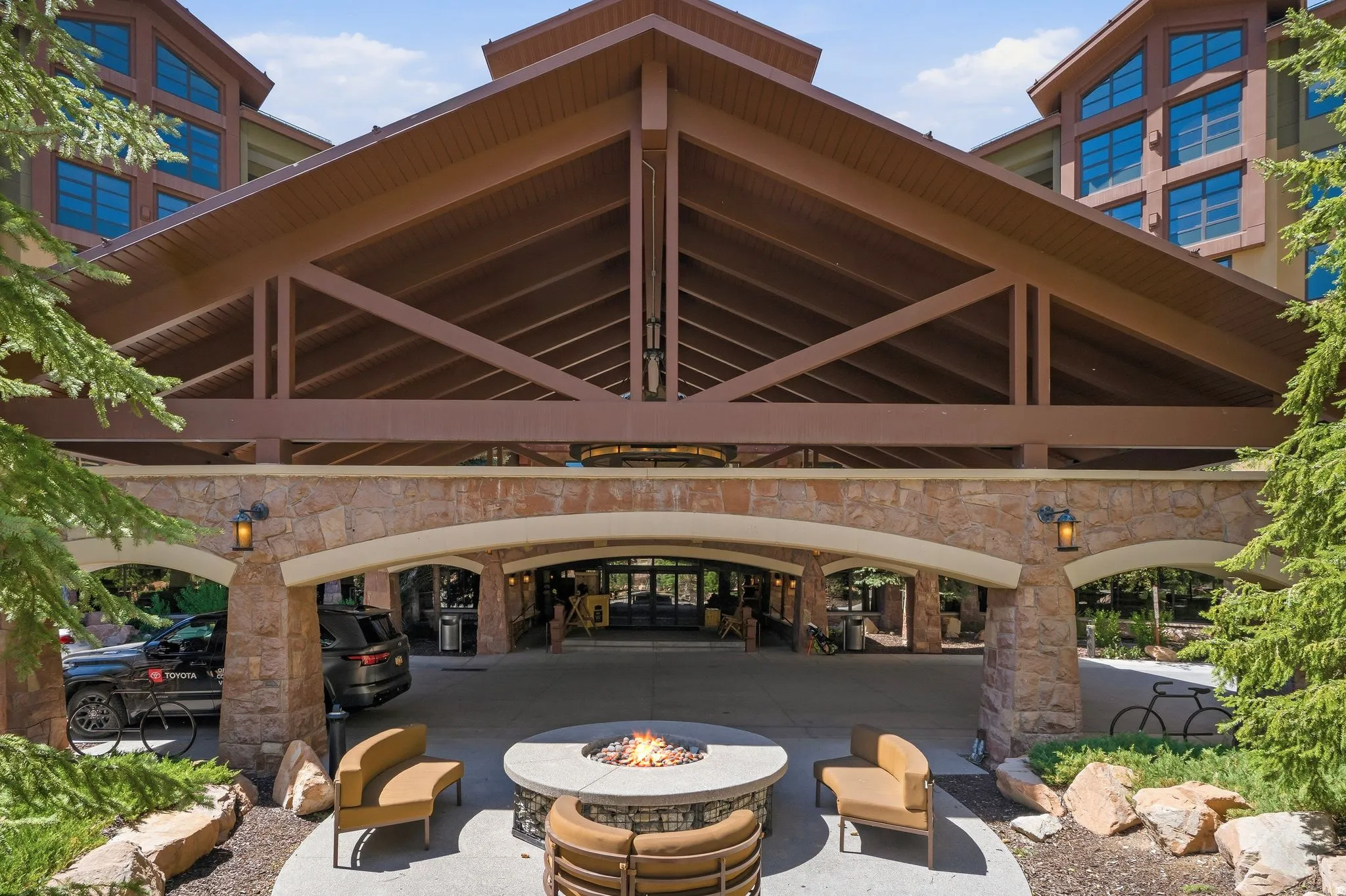 Stone and timber architectural facade with a grand porte-cochere