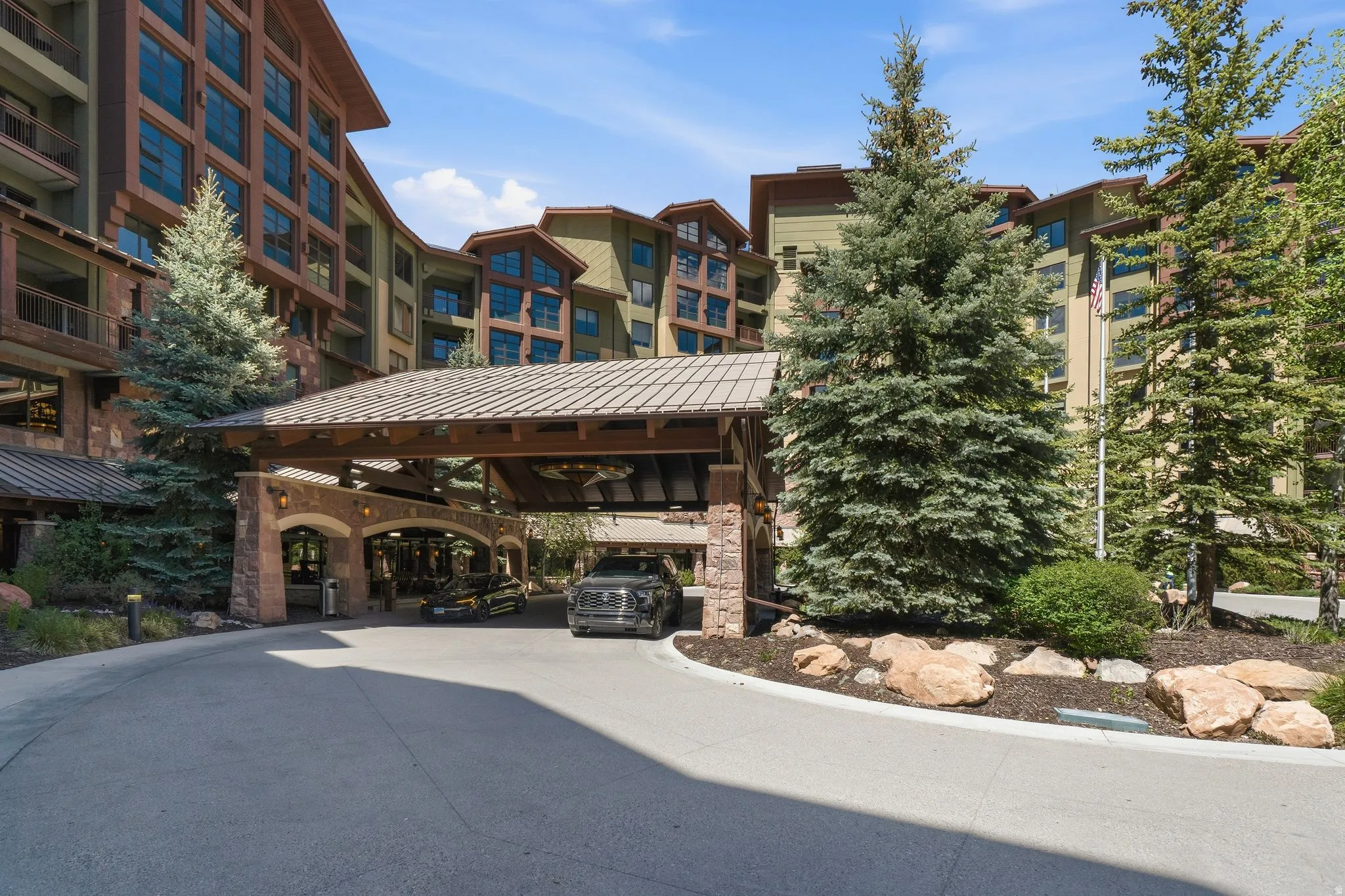 Grand porte-cochère entrance with stone columns and wood beam details