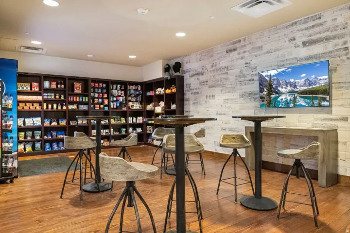 Wood-finish flooring throughout, featuring a white-washed plank accent wall with a mounted display
