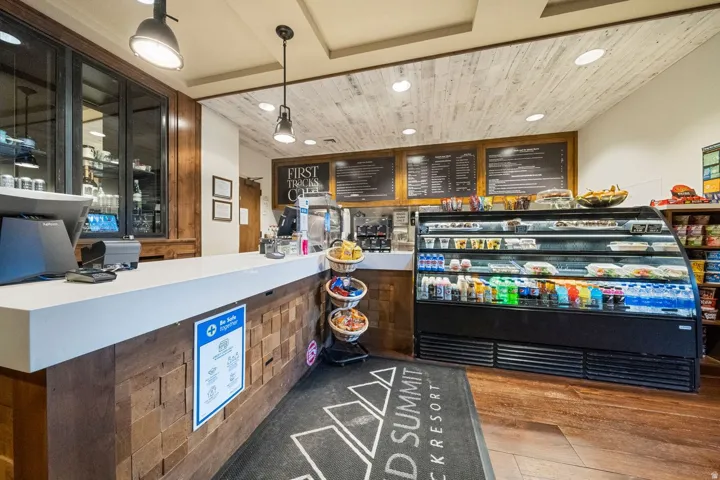 Retail counter featuring a white countertop and wood-finish paneling