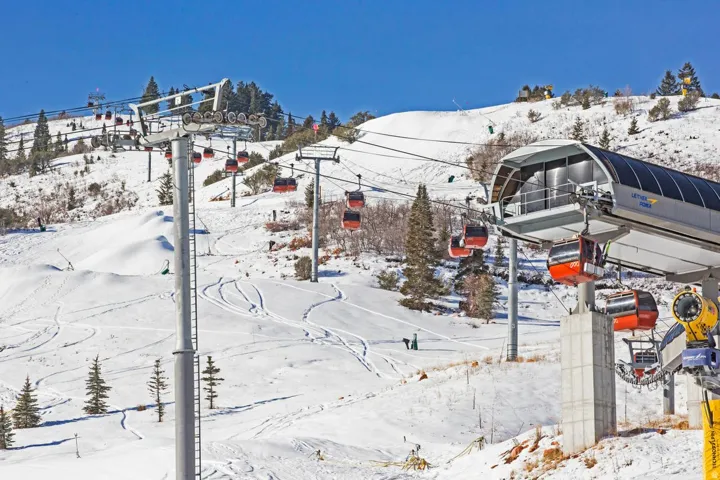 Ski resort landscape featuring multiple gondola lifts and snow-covered slopes