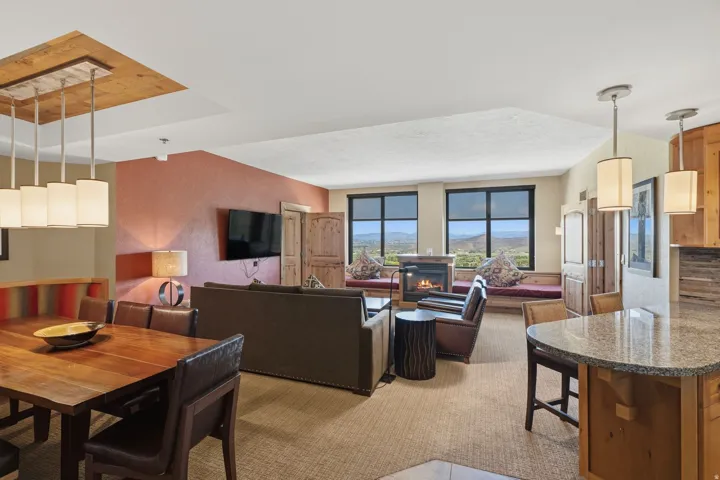 Open-concept living space featuring a living area with a fireplace, dining area, and kitchen