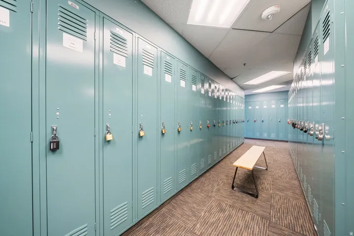 Corridor with rows of blue metal lockers