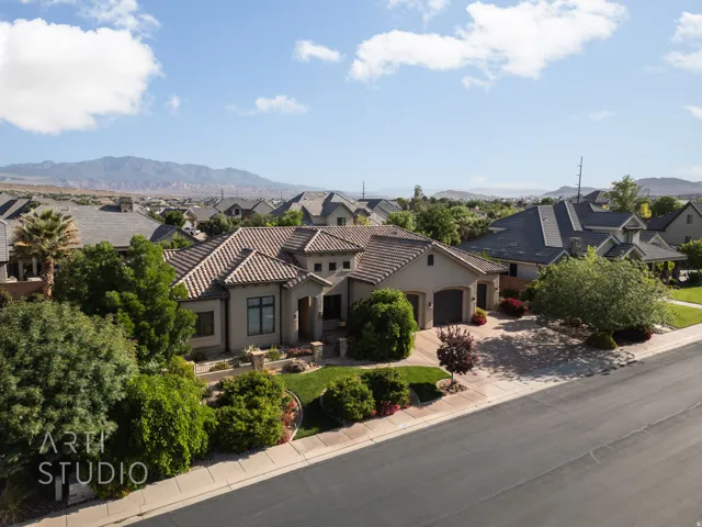 Contemporary-style residence featuring stucco exterior, a tile roof, and an attached two-car garage
