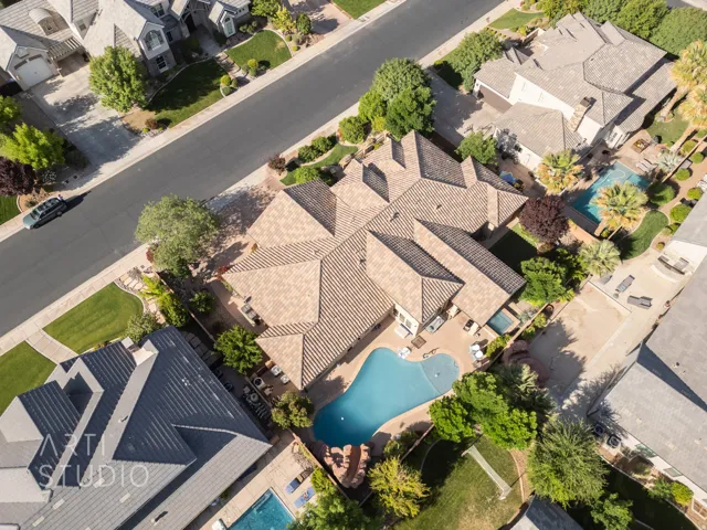 Expansive property featuring a curvilinear swimming pool, integrated spa, and surrounding patio space