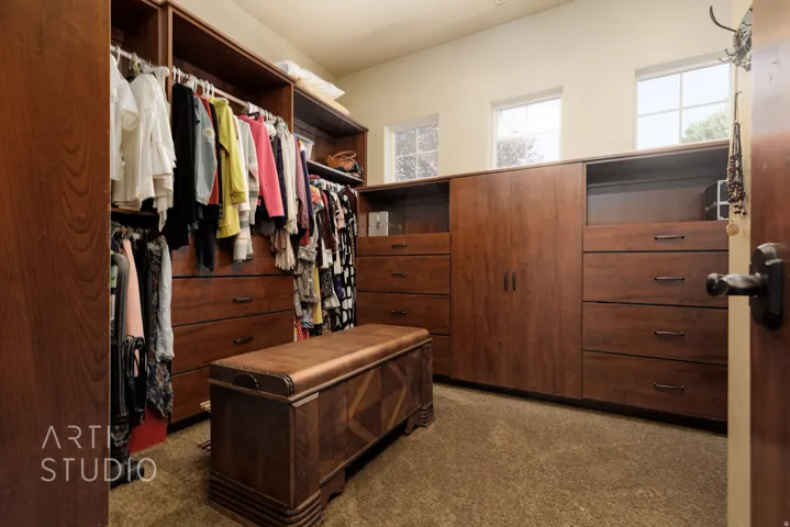 Custom wood-finish closet system featuring integrated drawers, shelving, and hanging rods