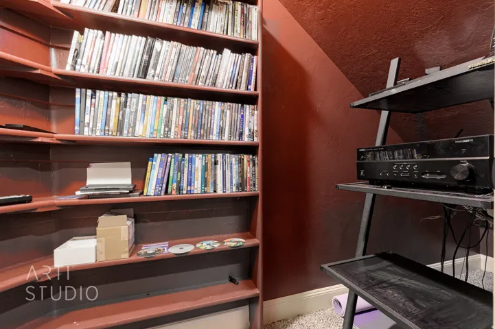 Built-in shelving unit with multiple tiers and a media console station
