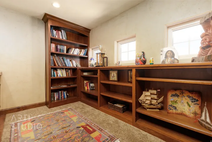 Integrated wood-finish shelving and built-in bookcases provide extensive storage