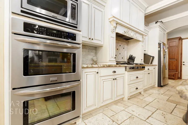 Gourmet kitchen featuring stainless steel double ovens and a built-in microwave