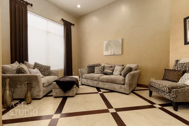 Spacious interior featuring a large window with privacy blinds, recessed lighting, and light-toned walls with a subtle texture