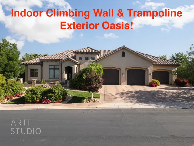 Stucco exterior featuring a tiled roof and a three-car garage