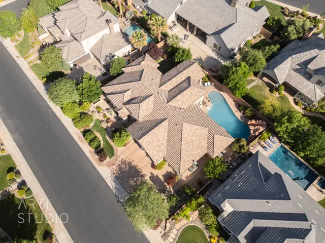 Aerial perspective showcasing a sprawling residential property with a multi-gabled tile roof