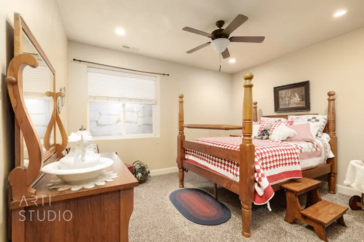 Carpeted room featuring a ceiling fan with integrated lighting, recessed lighting, and a window with blinds