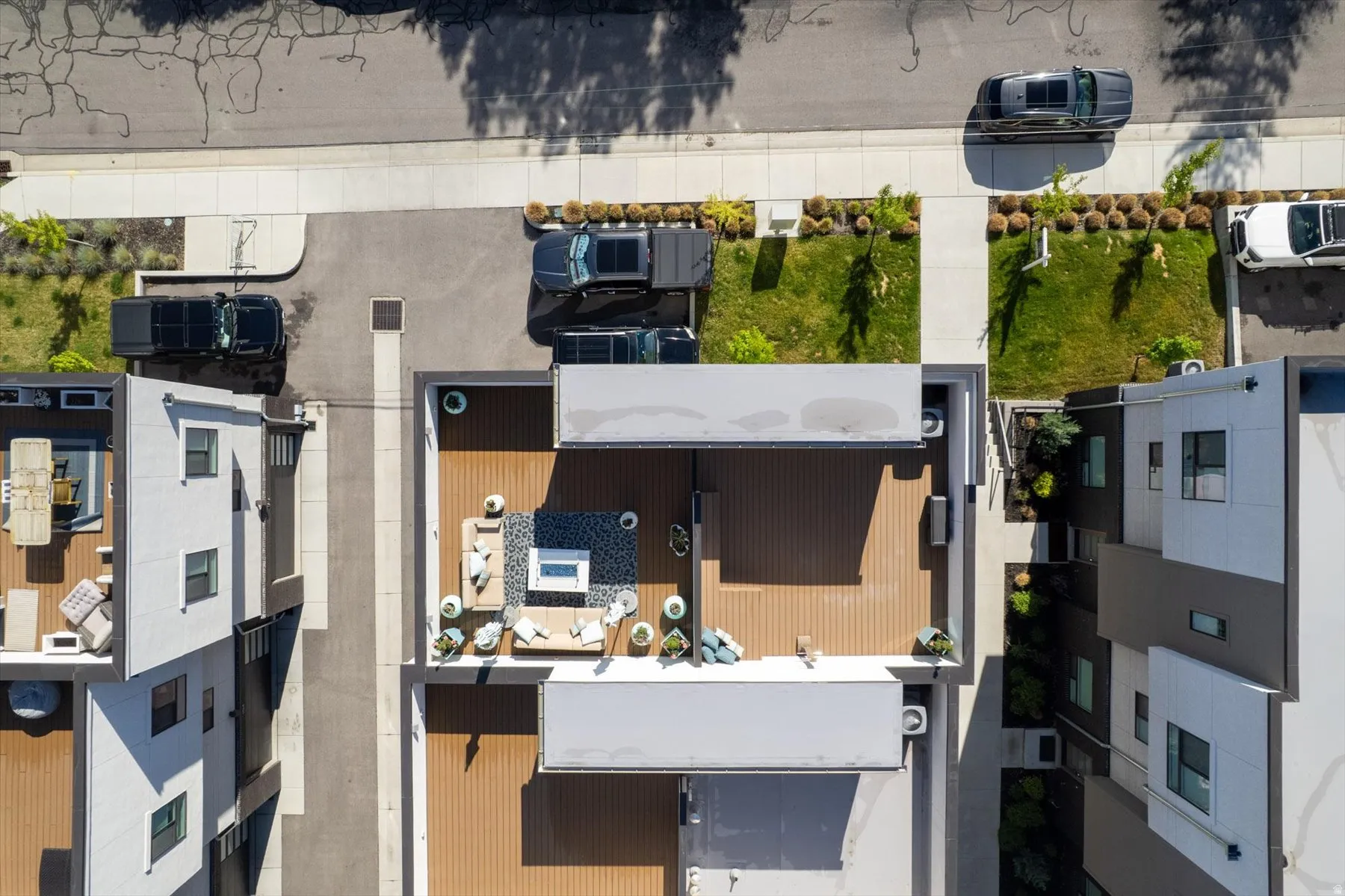 Spacious rooftop deck featuring wood-finish flooring, a built-in outdoor kitchen area, and a privacy wall