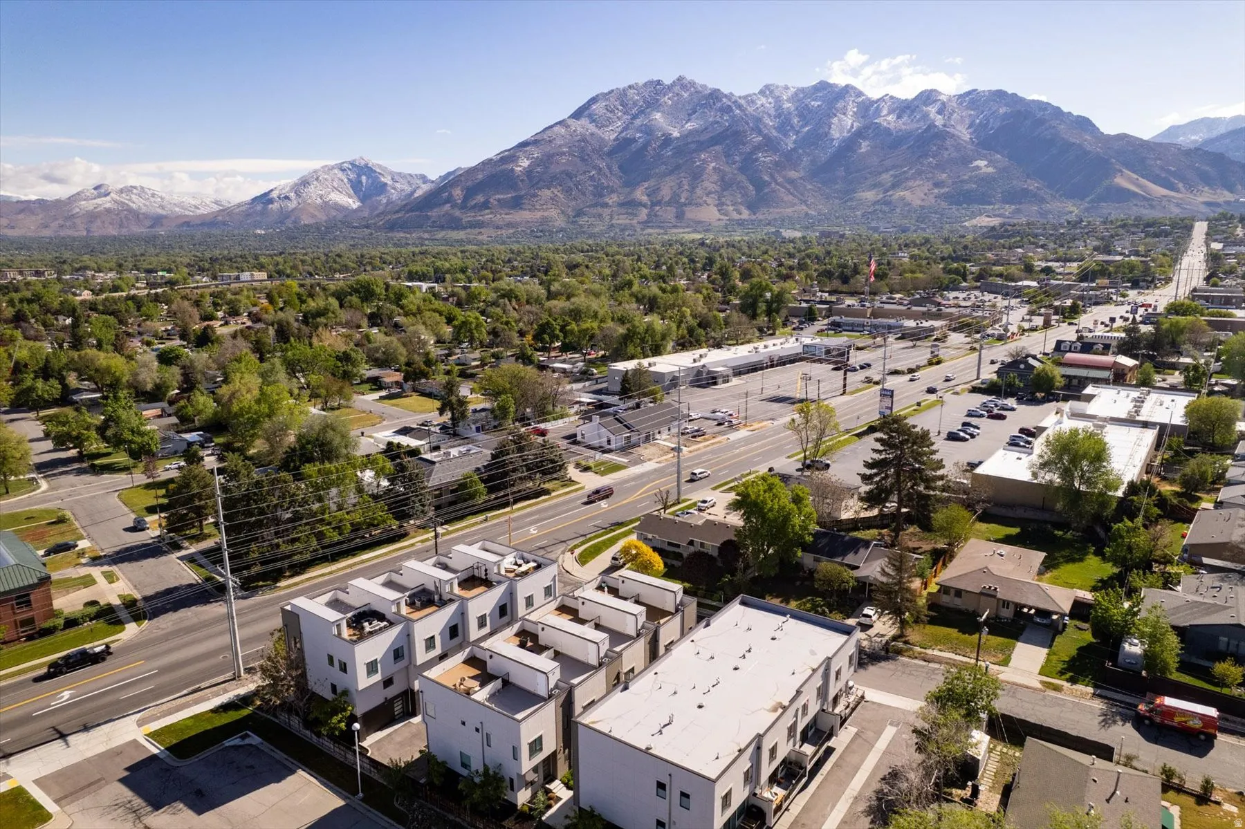 Modern townhomes with rooftop access, set amidst a developed neighborhood